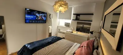 a bedroom with a tv on the wall and a bed at Medium size room for 2 in Toronto