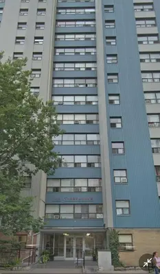 a tall blue building with a building at Medium size room for 2 in Toronto