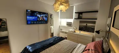 a bedroom with a bed and a flat screen tv at Medium size room for 2 in Toronto