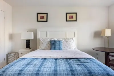 a bedroom with a bed with a blue and white bedspread at Newly constructed 3-Bedroom-Hyde Park- close to UWO and Hospital in London