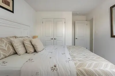 a white bedroom with a large white bed with pillows at Newly constructed 3-Bedroom-Hyde Park- close to UWO and Hospital in London