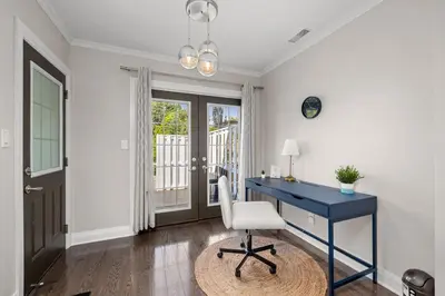 a blue desk with a white chair in a room at Entire Unit - Steps From History - 5 Mins To Beaches in Toronto