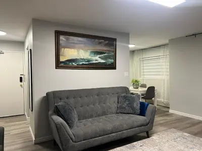 a living room with a couch and a painting on the wall at Modern 2 bedroom, 2 king beds, close to Hwy in Kitchener