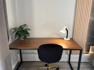 a desk with a chair and a lamp and a plant at Modern 2 bedroom, 2 king beds, close to Hwy in Kitchener