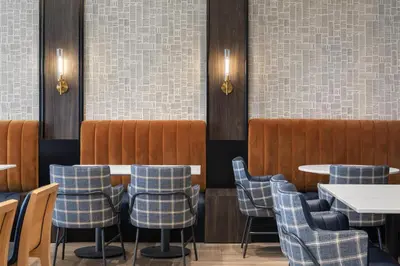 a dining room with tables and chairs and tiles at Hyatt Place Toronto Airport in Toronto