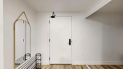 a hallway with a large white door and a mirror at Cozy 2 Bdrm 2 Bath Entire Suite - Centre Hamilton in Hamilton