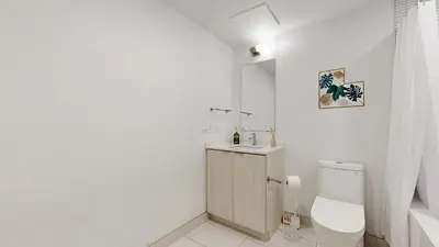 a white bathroom with a toilet and a sink at Cozy 2 Bdrm 2 Bath Entire Suite - Centre Hamilton in Hamilton