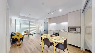a kitchen and living room with a table and chairs at Cozy 2 Bdrm 2 Bath Entire Suite - Centre Hamilton in Hamilton