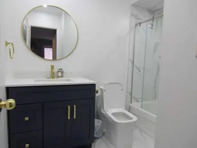 a bathroom with a sink and a toilet and a mirror at Spacious 5br Home W Parking In Mississauga in Mississauga
