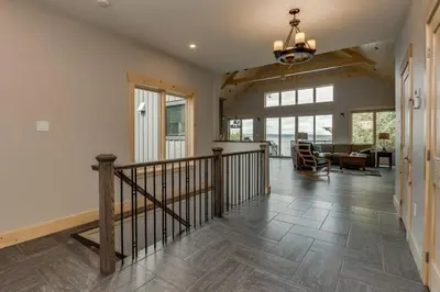 a living room with a staircase and a dining room at Waterfront 3 Bedroom Home in Port McNicoll