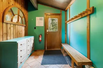 a bathroom with green walls and a wooden door at Stunning Mountain Getaway with Open Concept Design in Blue Mountains