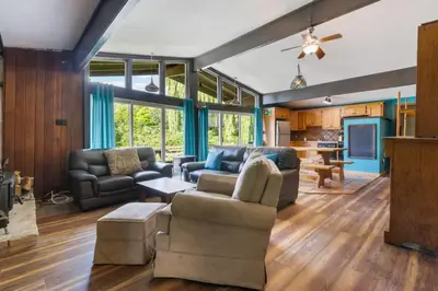 a living room with two couches and a tv at Stunning Mountain Getaway with Open Concept Design in Blue Mountains