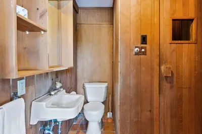 a bathroom with a toilet and a sink at Stunning Mountain Getaway with Open Concept Design in Blue Mountains