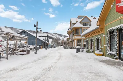 a snow covered street in a town with houses at Stunning Mountain Getaway with Open Concept Design in Blue Mountains