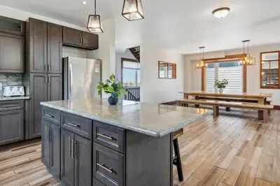 a kitchen with a large island in the middle of a room at 8 BR Luxury Swiss Style Chalet w Hot Tub in Blue Mountains