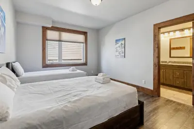 a bedroom with a large bed and a mirror at 8 BR Luxury Swiss Style Chalet w Hot Tub in Blue Mountains