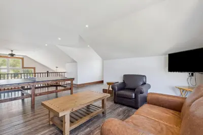 a living room with a couch and a table at 8 BR Luxury Swiss Style Chalet w Hot Tub in Blue Mountains