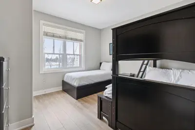 a small bedroom with a bed and a window at The 19th Hole at Blue with Hot Tub in Blue Mountains