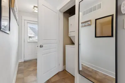 a hallway with a white door and a mirror at The 19th Hole at Blue with Hot Tub in Blue Mountains