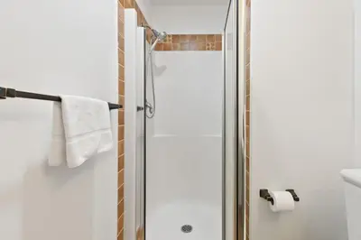 a shower with a glass door in a bathroom at Fore Seasons Escape with Golf in Backyard in Blue Mountains