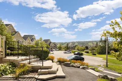a street in a residential neighborhood with cars parked at Fore Seasons Escape with Golf in Backyard in Blue Mountains