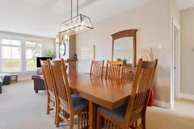 a dining room with a wooden table and chairs at Fore Seasons Escape with Golf in Backyard in Blue Mountains