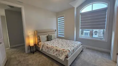 a bedroom with a bed and a large window at Grand Woodstock Luxe House 4BR in Woodstock