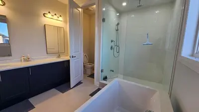 a bathroom with a tub and a shower and a sink at Grand Woodstock Luxe House 4BR in Woodstock