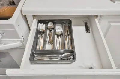 a drawer filled with silver utensils in a kitchen at Chic and Bright 1BR Apt with Free Wifi and Parking in Whitby
