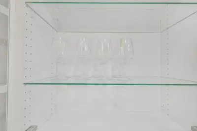 a glass shelf with a bunch of glasses on it at Chic and Bright 1BR Apt with Free Wifi and Parking in Whitby