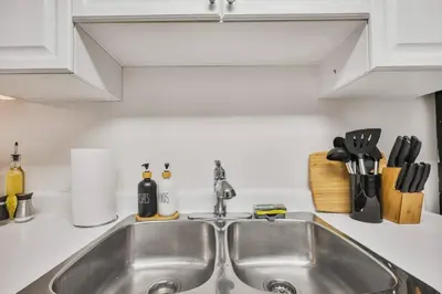 a kitchen counter with a sink in a kitchen at Chic and Bright 1BR Apt with Free Wifi and Parking in Whitby