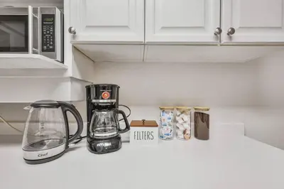 a kitchen counter with a coffee maker and a blender at Chic and Bright 1BR Apt with Free Wifi and Parking in Whitby