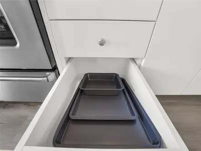 an empty kitchen drawer with two trays in it at Stylish 1BR Condo in Prime Location with Parking and Wi Fi in Kitchener