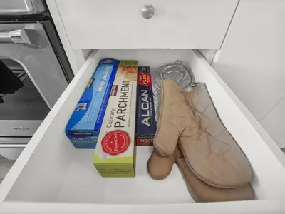 a drawer filled with books and shoes in a refrigerator at Stylish 1BR Condo in Prime Location with Parking and Wi Fi in Kitchener