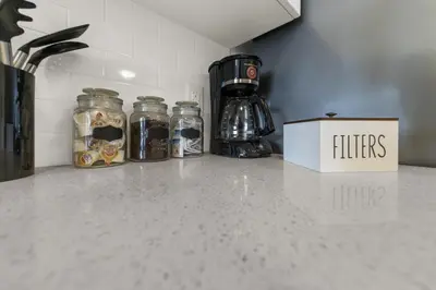 a kitchen counter with three glass jars on it at Stylish 1BR Condo in Prime Location with Parking and Wi Fi in Kitchener