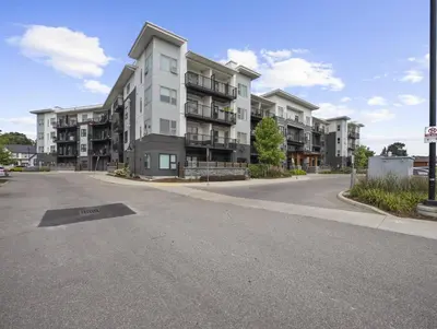 an empty street in front of a large apartment building at Stylish 1BR Condo in Prime Location with Parking and Wi Fi in Kitchener