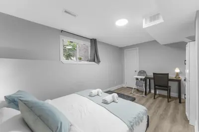 a bedroom with a bed with two stuffed animals on it at Modern 2-Bed, 2-Bath BSMT suite with Pvt Entrance Free Parking and Wi Fi in Pickering