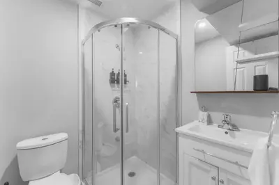 a bathroom with a shower and a toilet and a sink at Modern 2-Bed, 2-Bath BSMT suite with Pvt Entrance Free Parking and Wi Fi in Pickering