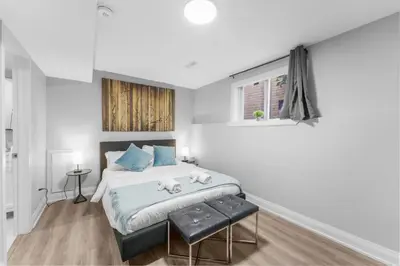 a bedroom with a bed with two stuffed animals on it at Modern 2-Bed, 2-Bath BSMT suite with Pvt Entrance Free Parking and Wi Fi in Pickering