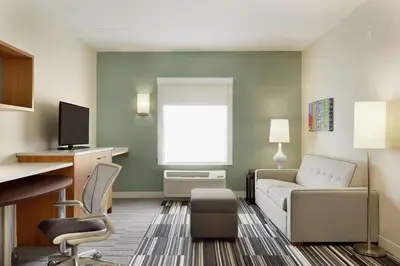 a living room with a couch and chairs in a room at Home2 Suites by Hilton Milton Ontario in Milton