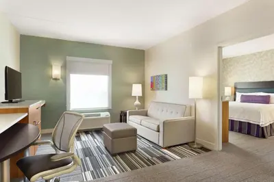 a hotel room with a bed and a desk at Home2 Suites by Hilton Milton Ontario in Milton