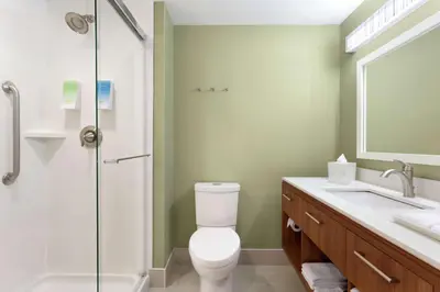 a bathroom with a toilet and a shower and a sink at Home2 Suites by Hilton Milton Ontario in Milton