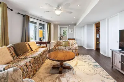 a living room with a couch and a table at Serene Waterfront Escape On Private Lane in Thornbury