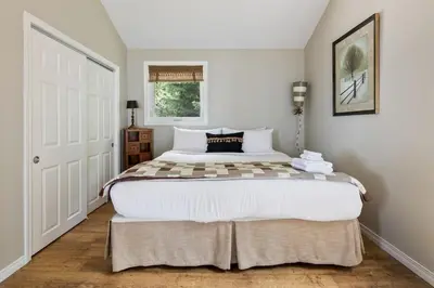 a bedroom with a large bed in a room at Serene Waterfront Escape On Private Lane in Thornbury