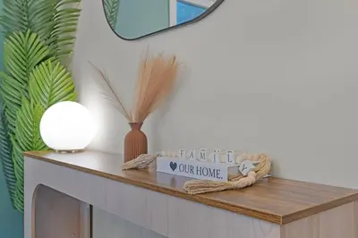 a table with a mirror and a vase on it at Niagara Retreat|HotTub|Sauna|Games|15 Min to Falls in Thorold