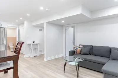 a living room with a couch and a table at Cozy 3BR 2 Bath Lower Level Close to Shops in Richmond Hill