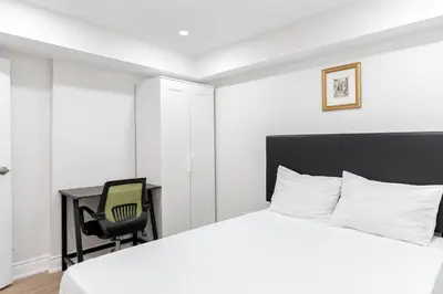 a bedroom with a bed and a desk and a chair at Cozy 3BR 2 Bath Lower Level Close to Shops in Richmond Hill