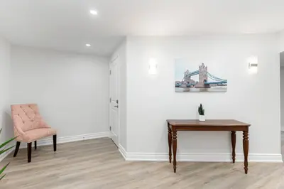 a room with a table and a chair and a painting at Cozy 1BR Lower Level Walking distance to shops in Richmond Hill