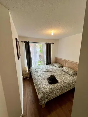 a small bedroom with a bed and a window at DT Townhome 1BR steps to transit in Toronto