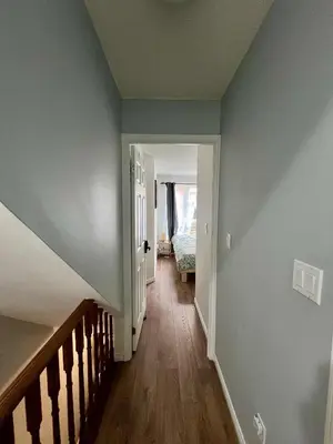 an empty hallway with blue walls and a staircase at DT Townhome 1BR steps to transit in Toronto